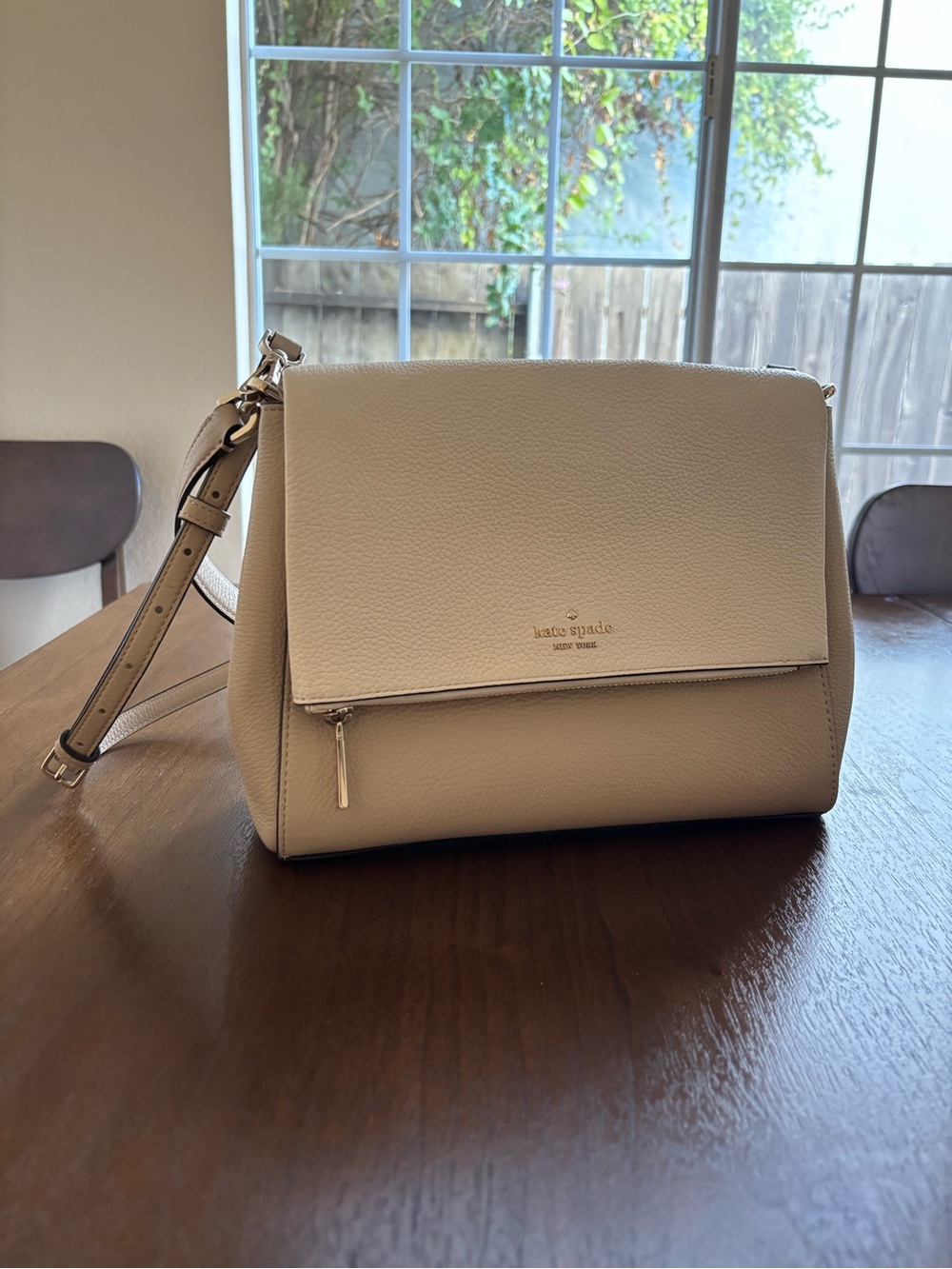 kate spade cream pebbled leather flap crossbody with front zip detail